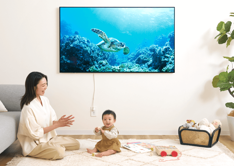 読者モデルの柚香さん、葵音（あおね）ちゃん（８ヵ月）が「ウォールフィットテレビ」の前で笑っている画像。